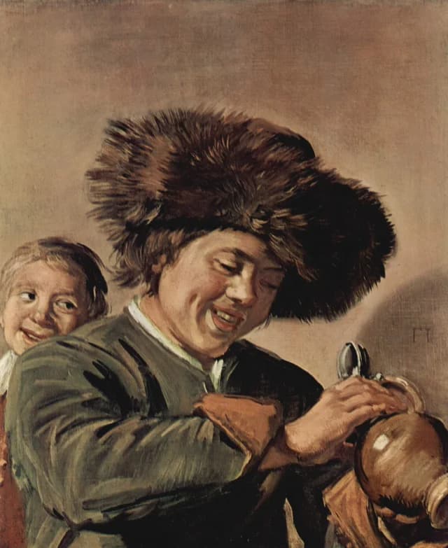 Two laughing boys with mug of beer