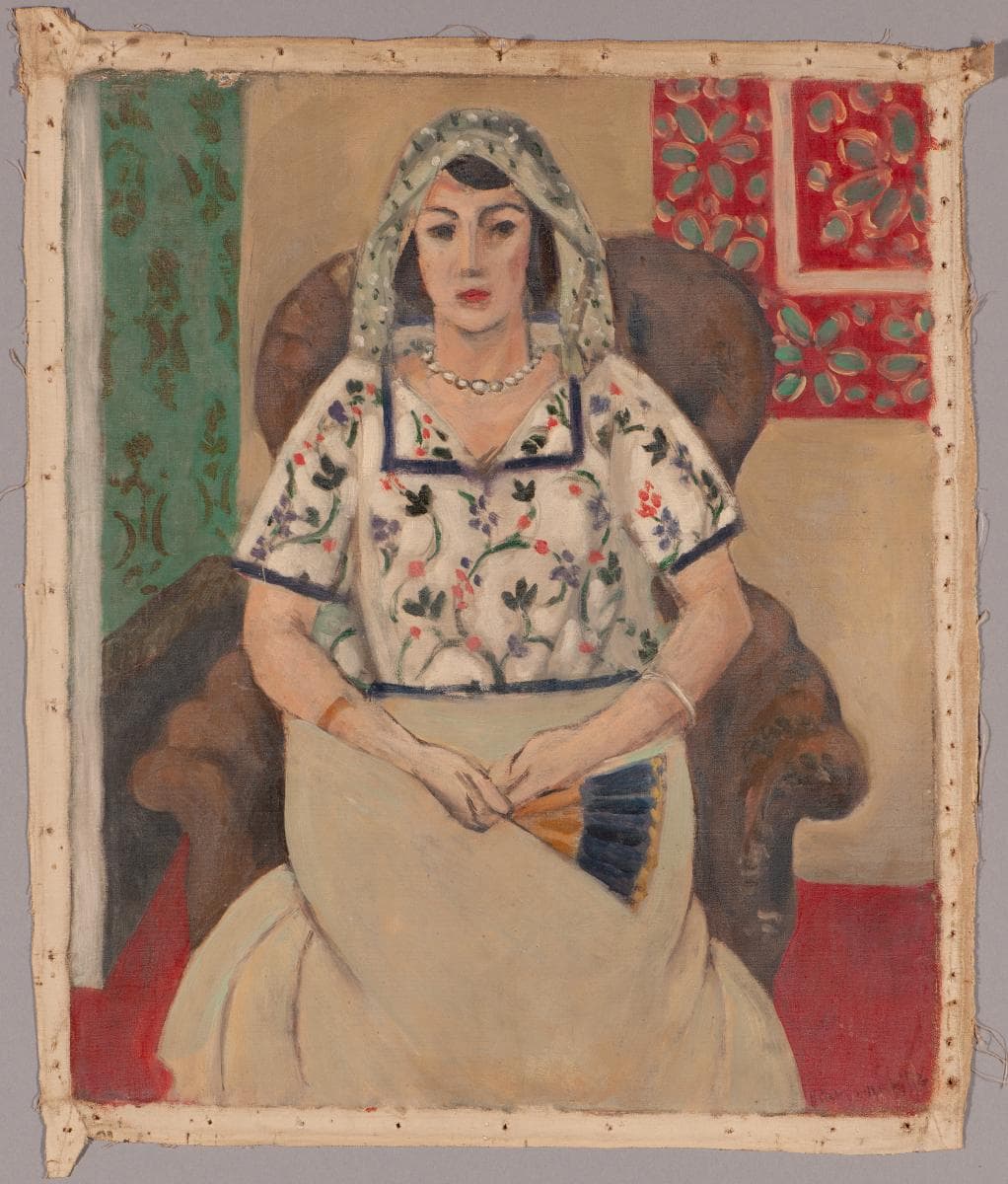 Woman sitting in an armchair